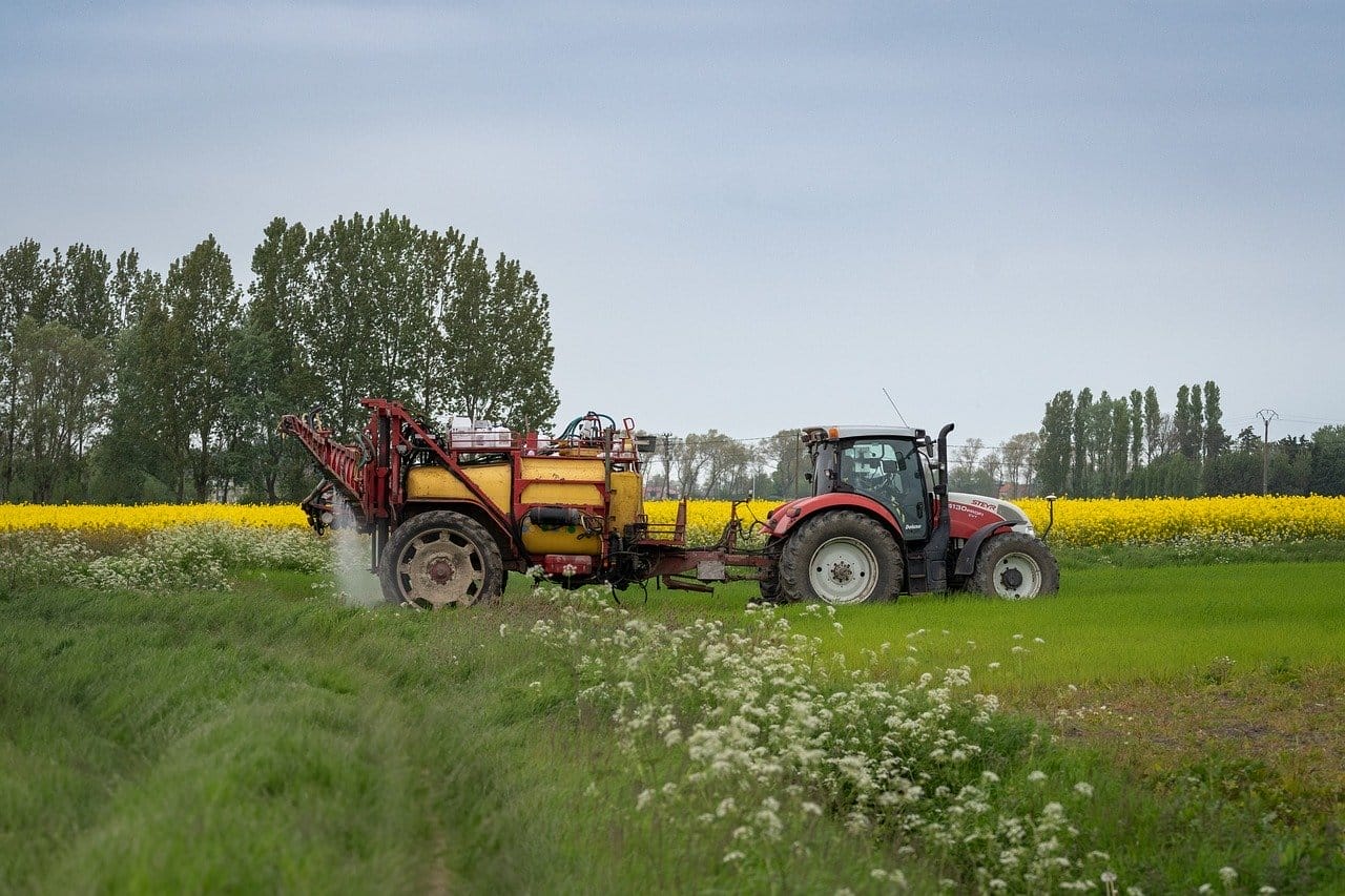 a cultivator spraying Paraquat to farm