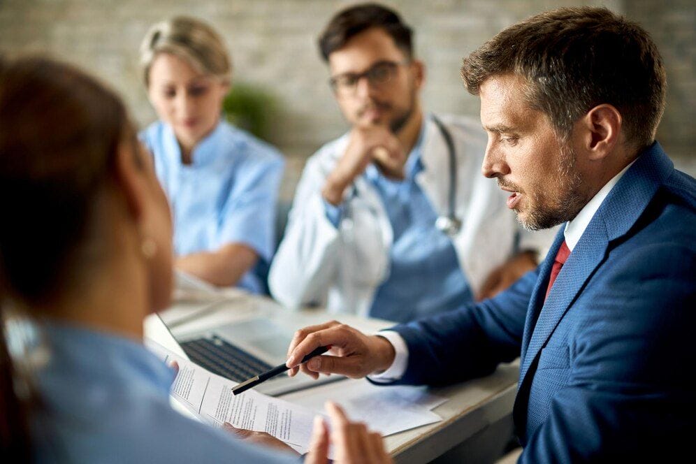 healthcare professionals consulting a lawyer and client